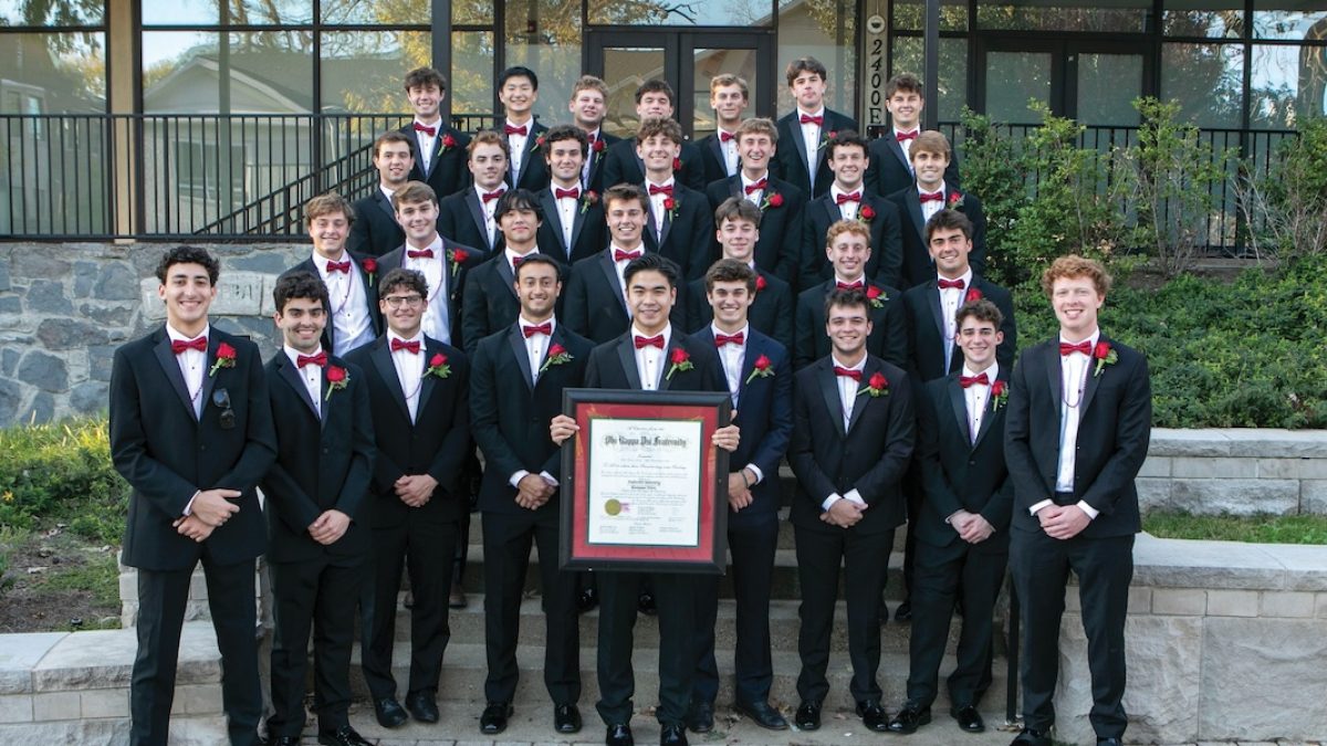 Newly initiated members of Tennessee Delta posing with the official charter in front of the chapter house.